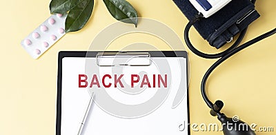 BACK PAIN on the Document with yellow background. Healthcare Stock Photo