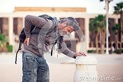Back pain, young man has a pain at lower back outdoor. People, health care, medical concept Stock Photo
