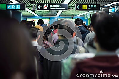 Back portrait crowd of passengers waiting for entering at the entrance of subway station during rush hours in morning Editorial Stock Photo