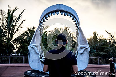 Man in front of megalodon shark jaws Editorial Stock Photo