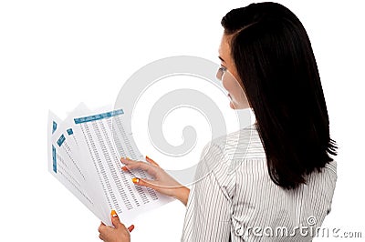 Back pose of businesswoman reading reports Stock Photo