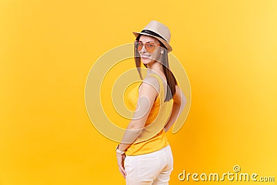 Back rear portrait view of young woman in straw summer hat, orange glasses looking turned back, copy space isolated on Stock Photo
