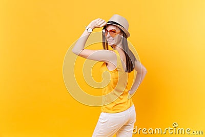 Back rear portrait view of young woman in straw summer hat, orange glasses put hands on head, copy space isolated on Stock Photo