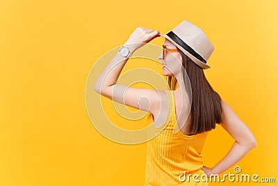Back rear portrait view of young woman in straw summer hat, orange glasses put hands on head, copy space isolated on Stock Photo