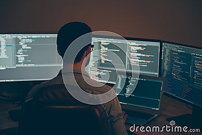 Back rear view photo of coder developing new security system to protect digital data base from being hacked using laptop Stock Photo