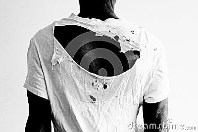 Back of a man wearing a ripped white t-shirt Stock Photo