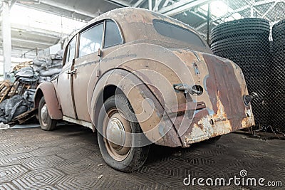 Closeup detail rusty abandoned forgotten antique oldtimer old car handle junkyard factory storage warehouse indoors Stock Photo