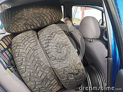 In the back seat of the car are wheels. tire fitting, shipping wheel repair Stock Photo