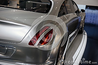 Back, side view of grey cool modern car with right dimensional fire or a rear light , which is divided into a parking Stock Photo