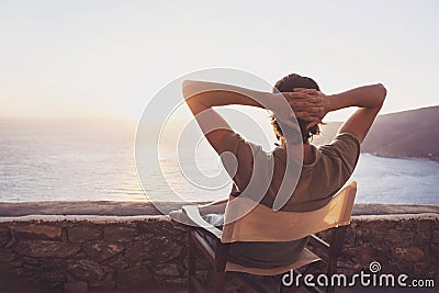 Back side of young man looking at the sea, vacations lifestyle concept Stock Photo