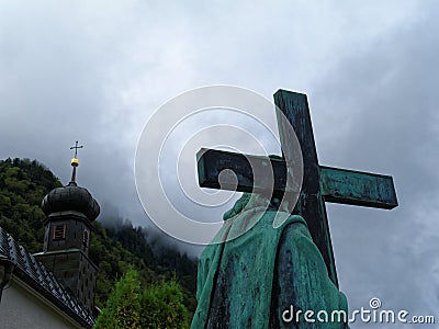 Jesus Christ stone statue with cross carried on shoulders Good Friday scene Stock Photo