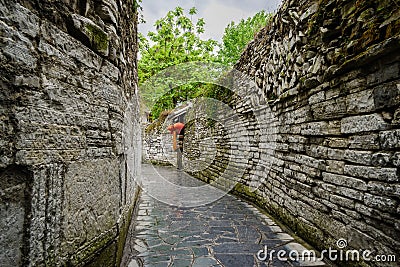 Back Street,ancient alley with stone-stacked walls,in cloudy spring Editorial Stock Photo