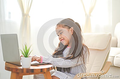 Back to School. asian Little girl using his laptop Stock Photo
