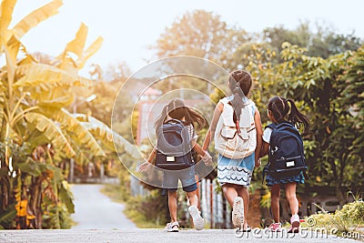 Asian pupil kids with backpack going to school Stock Photo