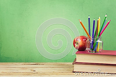 Back to school background with books, color pencils and apple Stock Photo