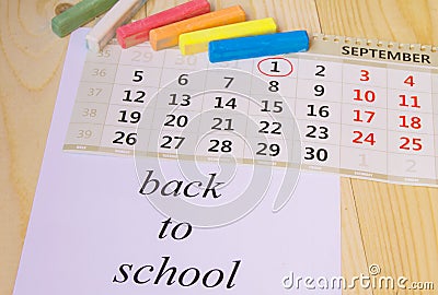 Back to school, calendar, colored chalk on wooden background Stock Photo