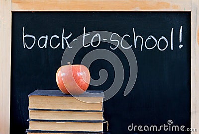 Back to school on chalkboard with apple & books Stock Photo