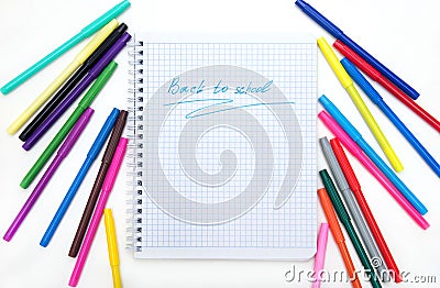 Back to school. Colorful markers and a notebook. A top flatly view of a white children`s desk with colourful markers Stock Photo