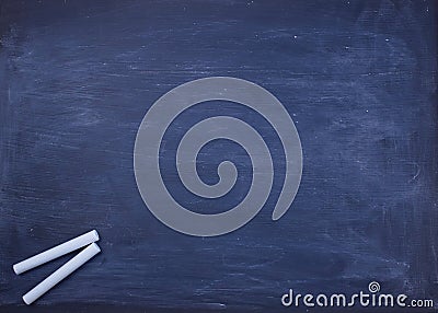 Back to school concept. Chalk pieces on black empty chalkboard with copyspace. Stock Photo