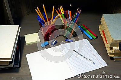 Back to school concept with empty exercise book for homework, pen, stationary supplies and schoolbooks Stock Photo