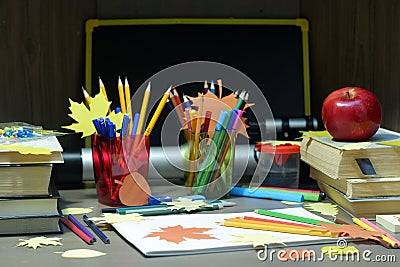 Back to school concept with empty sketchbook, colored pencils, stationary supplies and schoolbooks on brown wooden table with Stock Photo