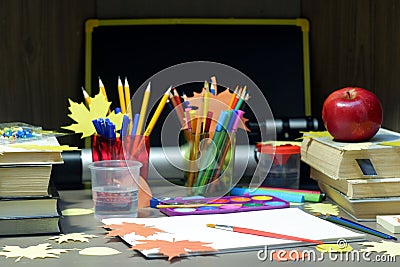 Back to school concept with empty sketchbook, watercolor paints, brushes, stationary supplies, blackboard, telescope and Stock Photo