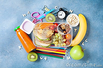 Back to school concept. Nutritional lunch box and colorful stationery on blue table top view. Stock Photo