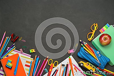 Back to School concept - office and student supplies on black chalk background. Space for text Stock Photo