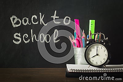Back to school. School supplies, copybook and pen. Copy space on chalkboard Stock Photo