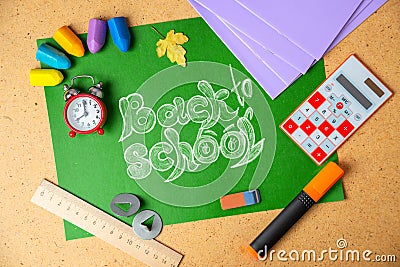 Back to school concept. School supplies on green board Stock Photo