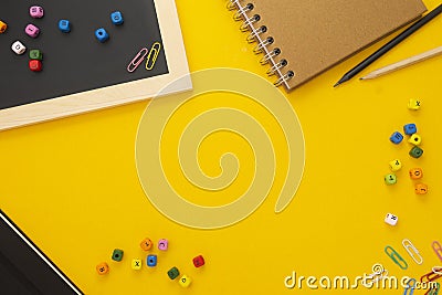 Back to school concept. Yellow background with notebooks and school supplies. Flat lay Stock Photo