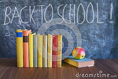 Back to school after the coronavirus lockdown, education supplies, books, message on blackboard Stock Photo