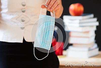 back to school during covid pandemics teacher with face mask Stock Photo