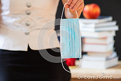 back to school during covid pandemics teacher with face mask Stock Photo