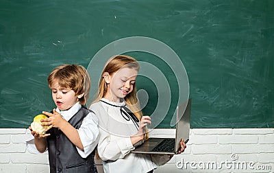 Back to school. Education. Happy smiling pupils drawing at the desk. Boy and girl from elementary school at the school Stock Photo