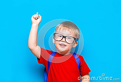 Back to school First grade junior lifestyle. Small boy in red t-shirt. Close up studio photo portrait of smiling boy in glasses Stock Photo