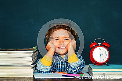 Back to school. Funny little boy pointing up on blackboard. Great study achievement. Stock Photo