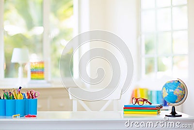 Back to school. Kids desk with books, globe Stock Photo