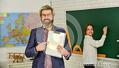 Back to school. modern education concept. teacher and child in classroom. change of duties. bearded man make notes in Stock Photo