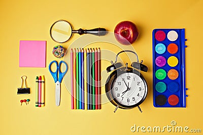 Back to school objects organized on yellow background. View from above Stock Photo