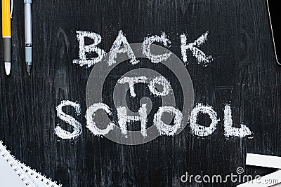 Back To School phrase written on a black wood background. Stock Photo