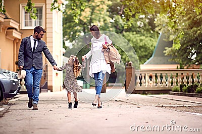 Back to school. pupil girl with backpack with her parents and going to school Stock Photo