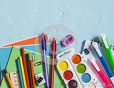 Back to school. School accessories - notebooks, pens, pencils, paint on a blue background, top view. Education concept. Flat lay Stock Photo