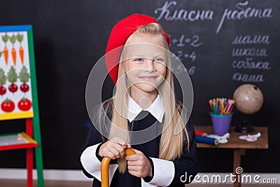 Back to school! A schoolgirl stands at the blackboard with a ruler. A schoolgirl answers the lesson. A first-grader near a chalk b Stock Photo