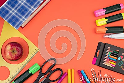 Back to school. Stationery on a salmon-orange color. color table. Office desk with copy space. Flat lay Stock Photo