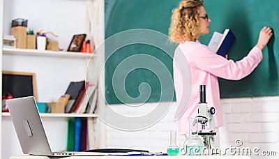 Back to school. student girl writing answer at blackboard. beaker and microscope. student doesnt use laptop. biology Stock Photo