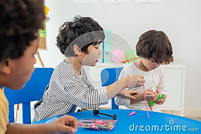 Back to school and summer course. Little children play colorful balloon in kindergarten class Stock Photo