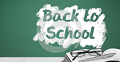 Back to school text on blackboard with glasses and book on desk Stock Photo