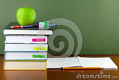 Back to school- textbooks and apple on the wooden desk Stock Photo