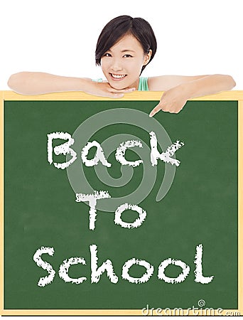 Back to school, young student girl point to blackboard Stock Photo